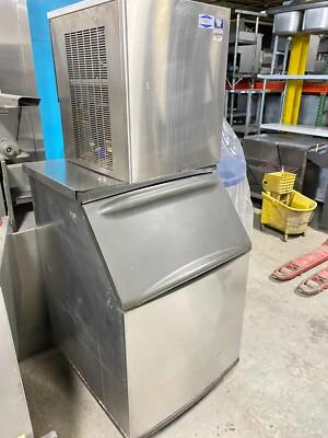 Light commercial ice machine being hand cleaned in a Utah office.