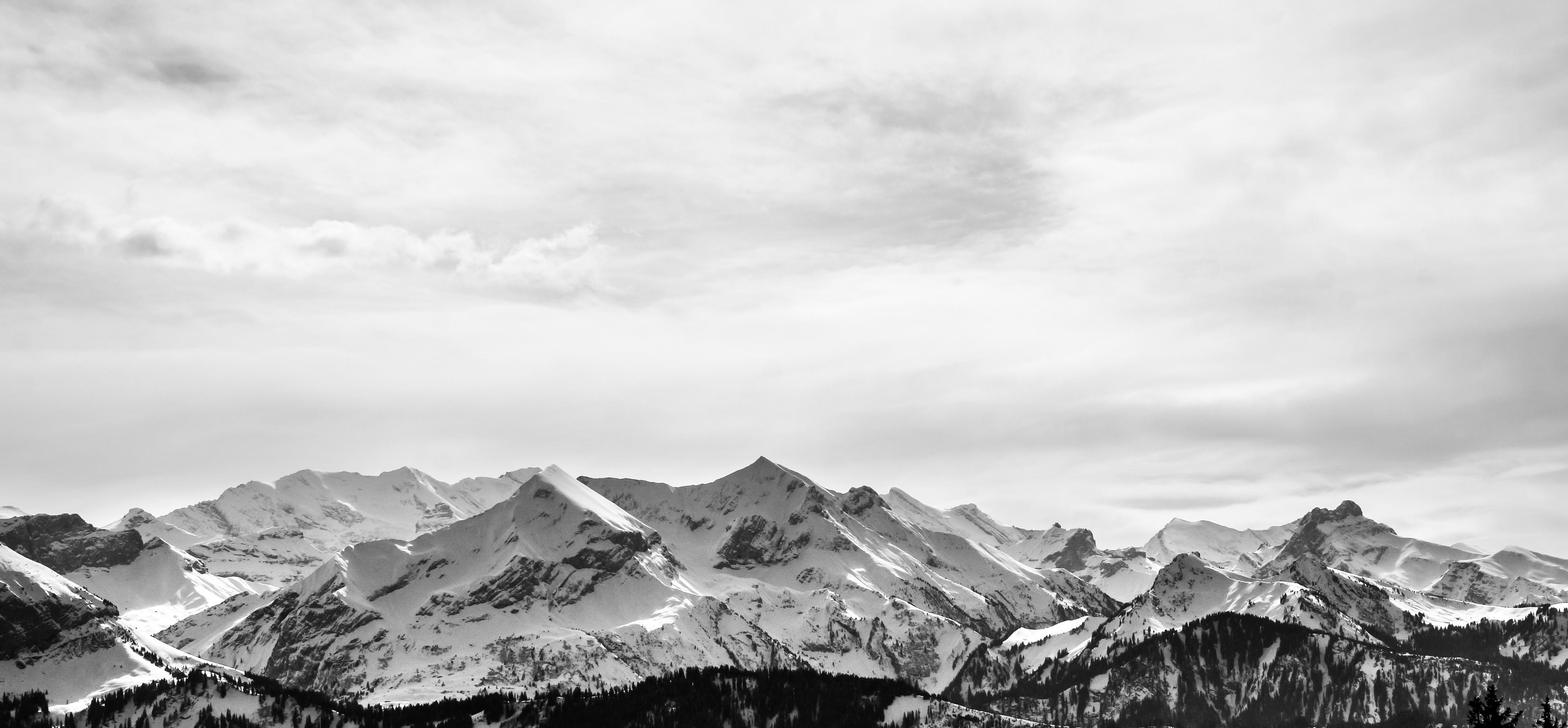 Snow-covered Wasatch peaks under low cloud