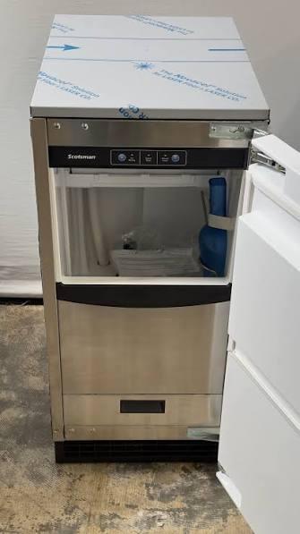 Residential undercounter ice machine being descaled in a Utah home.