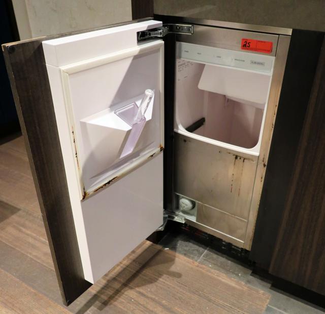 Residential undercounter ice machine being hand cleaned in a Utah home.